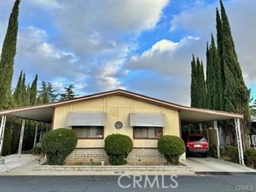 LOCATED in a FAMILY PARK- PRICE IMPROVEMENT
Back on the market after $17,000 worth of upgrades. NEW vinyl flooring, New painted kitchen cabinets, newly painted bathrooms and vanities, BRAND NEW water Heater, NEW thermostat and much more.

Welcome home to your beautiful mobile home located in a quiet and very well-maintained community FAMILY PARK. Open floor plan with lots of natural light. This home features 2 extra-large bedrooms with a large walk-in closet in the master, and 2 full bathrooms. The laundry room has storage and washer and dryer are included. The kitchen opens up to the dining room and then to the living room. The home also features a carport with enough space for 3 cars. This lot is the only lot in the park with a large back yard and French doors that lead out to a beautiful wood deck the overlooks the snowcapped mountains where you can enjoy your morning coffee and watch the sunrise. The yard has a very mature and high producing lemon and apricot tree. The home has newer carpet, upgraded A/C unit in 2020, and new ducting replaced in 2021. This family friendly park has a swimming pool, hot tub, sauna, dog park, club house, pickle ball courts, shuffleboard, fire pit, and picnic area. 
Location is perfect for day trips to Oak Glen, Big Bear, Palm Springs, and Cabazon. 

Property is being sold AS-IS. Space rent is $900 Water is included in space rent. 

Seller and seller's agent do not warrant any information. Buyers and Buyer's agent to do their own due diligence regarding all aspects of the property