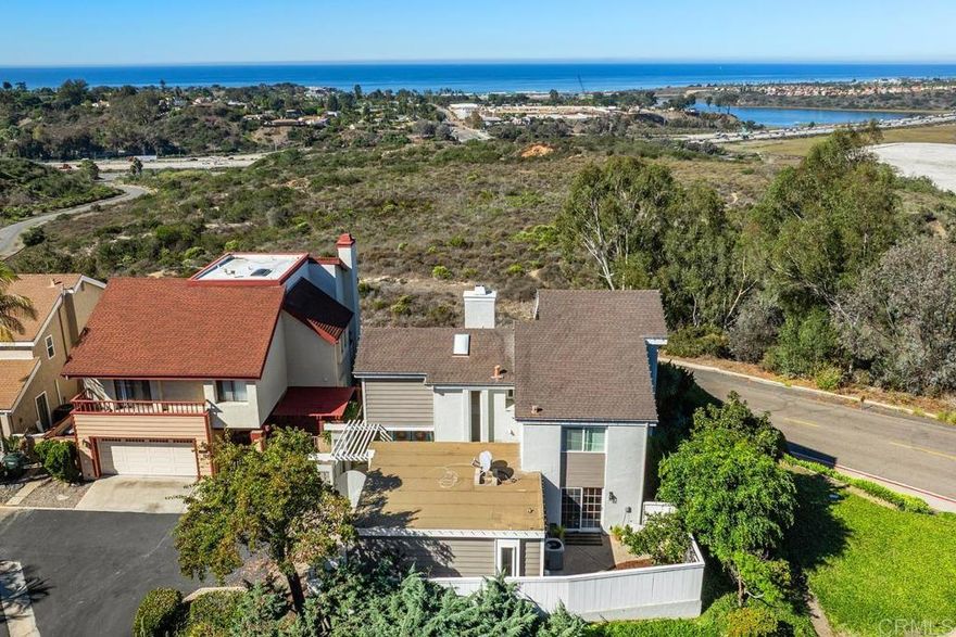 OPEN Sunday 2-4! Experience breathtaking coastal living from this rare corner-lot Skyloft home in Coastal Encinitas, offering sweeping 180° views from the Pacific Ocean to the Batiquitos Lagoon Ecological Reserve. This bright 3-bedroom, 2.5-bath residence features vaulted ceilings, engineered hardwood floors, modern bathrooms, and a newly remodeled rear deck designed to capture the panoramic horizon. Enjoy custom closets, a spacious two-car garage, and beautifully updated bathrooms with wood vanities, quartz countertops, and contemporary fixtures. Mid-Century Modern–inspired lighting adds timeless coastal elegance, while community amenities include a saltwater pool, spa, tennis and pickleball courts, dog park, playground, and clubhouse. A perfect blend of modern design, coastal beauty, and relaxed beach-town living.  Pictures of interior are Seller's pics from a few years ago, new updated pictures coming soon.
