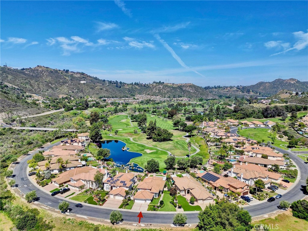 Stunning Single-Story Living on a Premium Golf Course Lot in Rancho San Diego. Exceptional 3,377 sq ft luxury home in Singing Hills at the Silverado Gated Community offering peaceful living and panoramic views on a highly desirable premium quarter-acre lot overlooking the Singing Hills Golf Resort at Sycuan Signature 12th hole. Step through the grand entry foyer into a bright and spacious open-concept floor plan with soaring 12 foot ceilings, expansive picture windows, and light-filled living and formal dining rooms for entertaining. The picturesque family room includes breathtaking floor-to-ceiling views of the manicured fairways and greens, fireplace, and entry to casual dining nook and chef’s kitchen, complete with large center island, granite countertops, garden window, triple-basin sink, instant hot water dispenser, dual convection ovens, pantry cabinetry, trash compactor, and private access to formal dining room. Retreat to the expansive double-door primary suite featuring a fireplace, sitting area, direct access to the backyard patio, and golf course views. The spa-inspired en-suite bathroom offers a jetted jacuzzi tub, separate walk-in shower, dual-sink vanity, water closet, and two entrances to an oversized walk-in closet. Two generously sized secondary bedrooms are located in a private wing, sharing a full bathroom with a dual-sink vanity with separate tub/shower and toilet room. A powder room, spacious utility closet, and laundry room complete the main level. Upstairs, a fourth bedroom with its own full en-suite bathroom and walk-in closet offers flexibility as a guest suite, bonus room, office, or added fifth bedroom, see floor plan for options. This meticulously maintained property includes a new roof (2024), upgraded energy-efficient windows, newer dual-zoned HVAC systems, and recent exterior stucco and eave painting. Enjoy the beautifully landscaped backyard with a wraparound covered patio, pool-sized turf lawn, walking path, private side yards with fruit trees, and built-in gas line for outdoor grilling. Watch golfers navigate the dramatic waterway challenge on the iconic 12th hole from the comfort of your lush landscaped backyard. Additional highlights include: Spacious 3-car garage with direct access to the home and side yard, pre-wired home security alarm, fire home sprinkler system, No Mello Roos Tax, and Low HOA with gated entry, tree-lined streets, parks, and home refuse collection. Located only 15 miles from downtown San Diego.