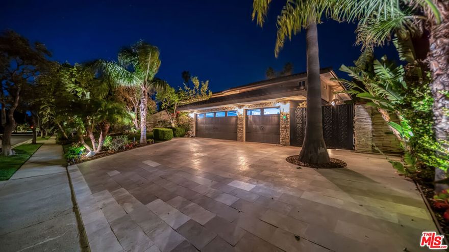 Exquisite Mediterranean Estate in Chatsworth! Welcome to this elegant, reimagined beauty in the heart of Chatsworth! Nestled on an expansive 18,000+ SQFT lot, this luxurious 5-bedroom, 4-bathroom residence offers nearly 4,300 SQFT of living space, showcasing high-end finishes and impeccable craftsmanship.From the moment you enter, you'll be captivated by soaring ceilings, stunning custom arches, and gleaming marble floors bathed in natural light. The state-of-the-art chef's kitchen is a true masterpiece, featuring a 6-burner gas Wolf range, built-in custom Sub-Zero refrigerator, oversized eat-in island, skylight, dramatic marble backsplash, and stainless steel farmhouse sink. Designed for grand entertaining, the formal living and dining areas boast coffered ceilings, Roman/Greek columns, dazzling chandeliers, and an elegant White Carrara marble fireplace. A second living room on the lower level offers a full wet bar, Italian-inspired fireplace, and custom sliding doors leading to the breathtaking backyard.Step outside to your private oasis, where travertine floors, an expansive patio, and a full outdoor kitchen create the ultimate indoor-outdoor living experience. Take a dip in the sparkling pool, surrounded by lush greenery and resort-style landscaping. The luxurious primary suite features a private balcony, generous walk-in closet, sunken jetted tub, glass-enclosed shower, and dual vanities with a makeup counter. With two additional bedrooms upstairs and two on the lower level, this home offers ample privacy and space for family and guests. Owned Solar! A custom 3-car garage with a workbench and storage completes this extraordinary home. This estate truly has it all elegance, space, and resort-style living! Don't miss this rare opportunity! Schedule your private showing today! CLICK ON THE VIRTUAL TOUR LINK FOR A FULL VIDEO.