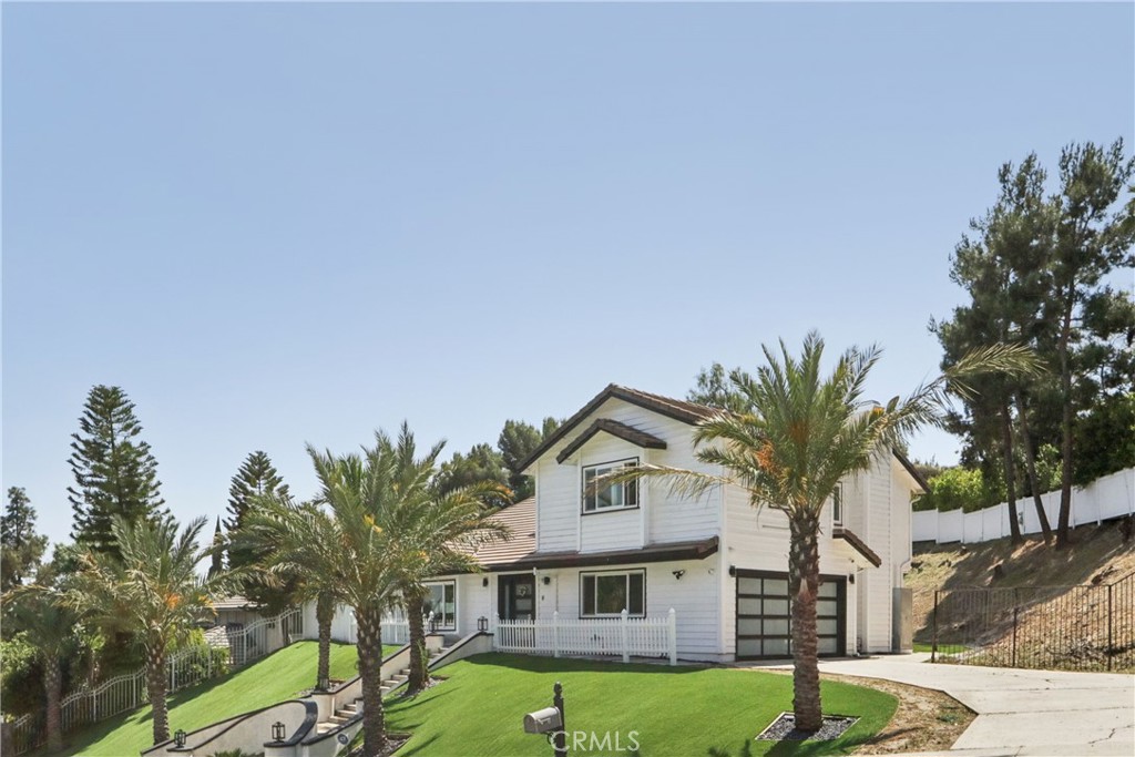 Stunning newly remodeled beauty located in Prime Granada Hills north or Rinaldi neighborhood!!! Home was completely remodeled in 2023 with modern finishes. Beautiful entertainers open floor plan featuring 5 bedrooms and 4 updated baths with over 2400 sqft of living space all sitting on just under 16,000 sqft of all private land. Large living room & dining opens to the custom one of a kind modern chef's kitchen with large island, quartz counters and stainless steel appliances, separate family room with gas fireplace. The primary room features a private balcony, walk in closet with custom built-ins and an en-suite primary bathroom. The large private back yard features a covered patio, play area, and so much space to add and pool/spa, BBQ area, etc. Additional features include tiles floors all through out the first level and laminate floors throughout the second floor, updated dual pane windows, electrical shades, glass stair rails, updated A/C and Heat, finished 2 car attached garage with tile floors, newer vinyl fence all around the property, beautiful curb appeal and so much more.