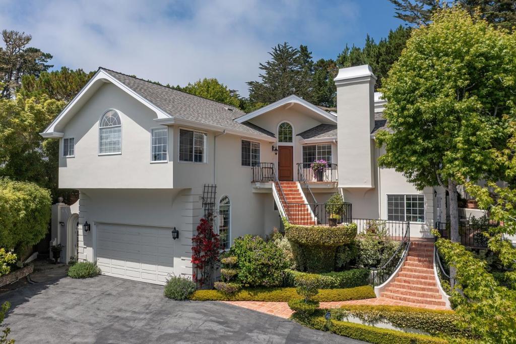 Nestled in the serene heart of Pebble Beach, this beautifully reimagined home combines contemporary luxury with the natural surroundings of forested landscapes and ocean vistas. Spanning three thoughtfully designed levels, the residence embraces indoor-outdoor living with expansive decks, private terraces, and lush gardens that offer a true sense of retreat. At its core, a sophisticated chef's kitchen showcases custom cabinetry, Caesarstone countertops, a Sub-Zero refrigerator, and a Viking gas range. Sunlight fills the formal dining room, generous living space, and cozy family area, thanks to the home's south-facing orientation. The primary suite serves as a refined sanctuary, complete with a sitting room, fireplace, spa-inspired bath, and walk-in closet. Downstairs, en-suite bedrooms provide privacy for guests or family, while a versatile main-level studio with a luxury bath offers options for a guest suite, home gym, or office. An oversized two-car garage with soaring 13-foot ceilings is lift-ready for up to four vehicles. With features like a backup generator, dual-zone heating, and premium insulation, this property ensures comfort and peace of mind year-round, all just minutes from world-class golf, dining, and coastal charm.