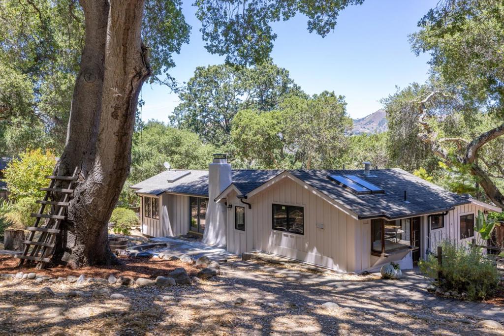 Robles Del Rio Cottage and Guest House. Beautifully preserved 1930's cottage on a corner lot across from the meadow. Almost 1/2 acre. Scenic oak studded setting with tree views from every room. Great room featuring hardwood floors, open beam ceilings, and rock wood burning fireplace. Lovely outdoor spaces. Detached 528 sq. ft. guest house, 1 bedroom and 1 bath and a cozy rock fireplace. Enjoy the best of village life and country living with room for guests.