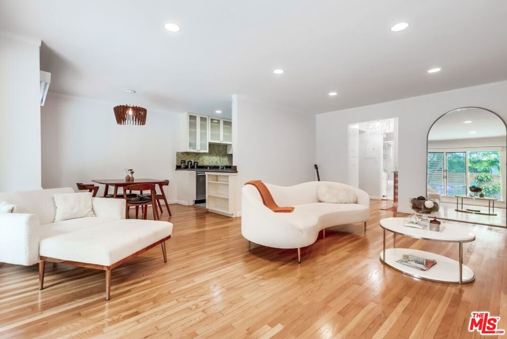 Welcome to your dream home in the heart of vibrant West Hollywood! This stunning 2-bedroom, 2-bathroom condo, nestled on the first floor of the iconic Lawford Building (est. 1957), is a light-filled sanctuary perfect for those seeking style, comfort, and an unbeatable location. Bathed in natural light from an abundance of windows, this unit boasts a breezy, open floor plan that feels both spacious and inviting. Step into the beautifully appointed living and dining area, where gleaming hardwood floors and recessed lighting create a warm ambiance day or night. The kitchen is a chef's delight, featuring sleek counters, a dishwasher, range, microwave, and refrigerator all ready for your culinary adventures. The primary bedroom is a true retreat, complete with an en-suite bathroom showcasing a luxurious, newly renovated steam shower for ultimate relaxation. The second bedroom offers an oversized walk-in closet, providing ample storage and versatility for guests, a home office, or a roommate. Located in a prime West Hollywood spot, you're just steps away from trendy bars, top-notch restaurants, and endless entertainment options. This stylish 21-unit Mid-Century modern complex is well-maintained, with a beautifully landscaped exterior, a sparkling pool, and a welcoming community of residents that give the building its unique charm. Enjoy the convenience of first-floor access with minimal steps, controlled entry for added security, and a quiet position within the building, far from street noise. Water and trash are included in the rent, making life here as effortless as it is enjoyable. Live in a piece of Hollywood history once home to Rat Pack legend Peter Lawford and embrace the good life sipping cocktails by the pool or exploring the vibrant neighborhood. This condo is more than a place to live; it's a lifestyle waiting for you to call it home. Schedule a tour today and discover why this is the perfect place for you!