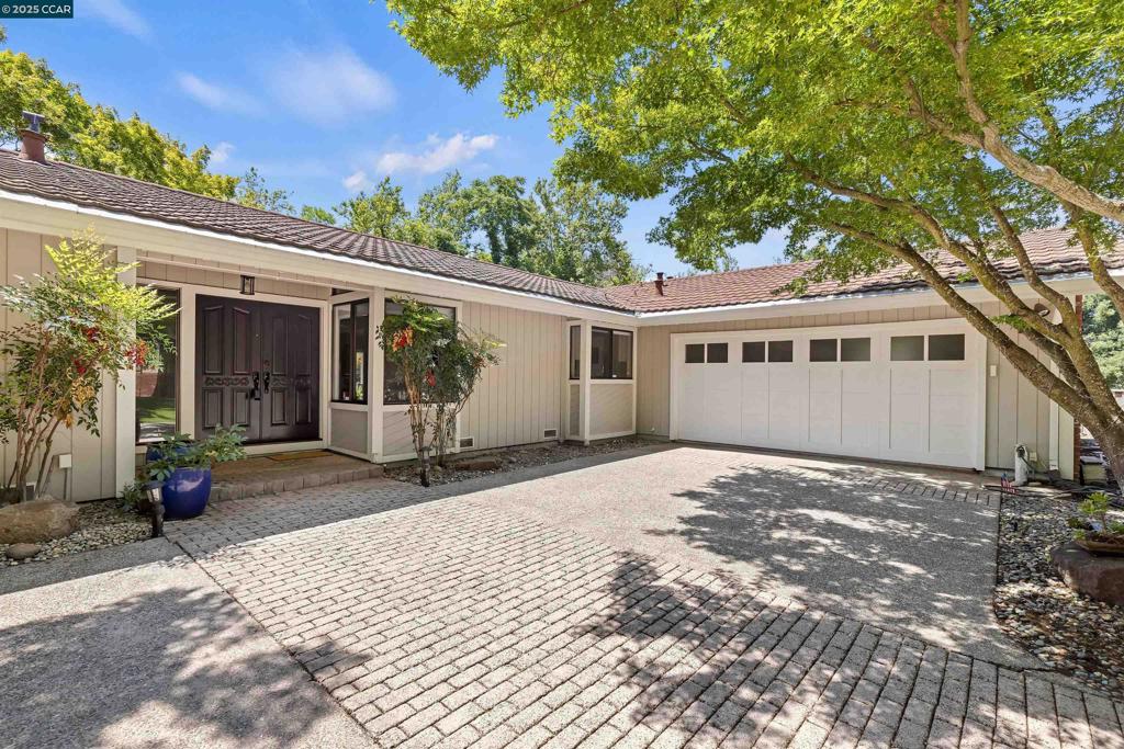 Remodeled single story 4 Bedroom, 3 Bathroom Rancher w/ amazing yard, updates throughout & amazing 4+ car garage spaces located in prime Alhambra Valley of Martinez. Beautifully remodeled throughout w/ an open floor plan & great entertaining spaces, many rooms w/ vaulted ceilings & more. Upon entry, you are captivated by the views of the amazing yard & beautiful Living Room w/ vaulted ceilings, walls of glass to capture yard views, raised panel walls centered by the wood ascent wall. The functional Kitchen features ample cabinets & quartz countertops, ss appliances, wine fridge & peninsula bar. The adjacent Family Room is spacious w/ entertainment center & woodburning fireplace. At the rear of the house is an ideal primary bedroom that is expansive & a welcome retreat featuring vaulted wood plank ceilings, large sliding glass door & updated primary bath. There are two large, attached garages for the car or hobby enthusiasts capable of holding up to 5 cars. The backyard is an oasis surrounded by many soaring trees & backing to a creek. Large side yards, sport court, decks/patios, grass play area, gardening beds, green house & more. Country location, but close to top shopping, restaurants, schools & freeway. This rare opportunity does not come by often!