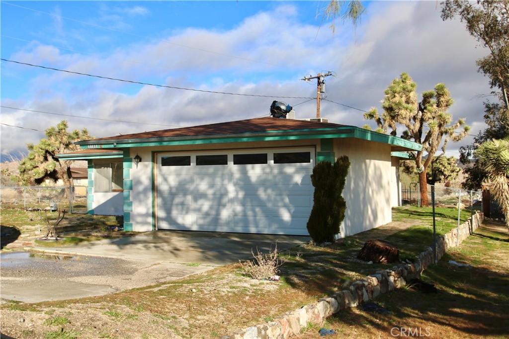 Discover the charm of Yucca Valley with this cozy fixer-upper! Embrace the vibrant local scene with nearby shops, restaurants, and outdoor adventures. Explore scenic hiking trails and immerse yourself in Southern California's natural beauty. This 2-bedroom, 1.5-bath home offers 1051 square feet of living space, an attached garage, and endless possibilities for renovation. With a spacious 10,800 square foot lot, unleash your creativity and transform this property into your dream oasis. Ready to make it yours?