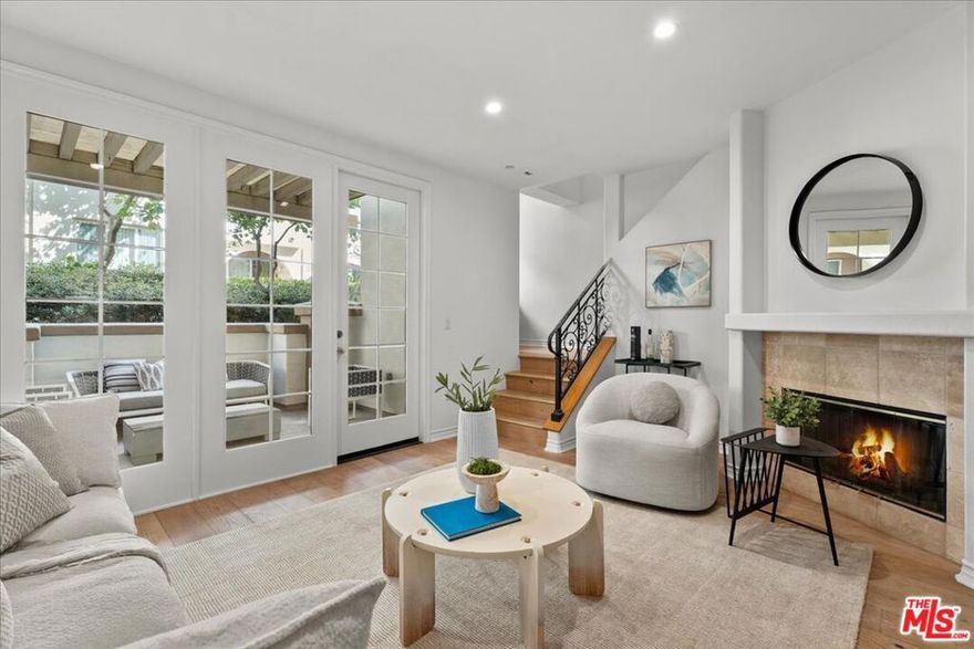 Hot Home!! Beautifully upgraded townhome-style condo in the sought-after Villa d'Este community, designed with the charm of an Italian boutique hotel. You will immediately notice the luxurious touches in this home that sets it apart from other homes in Playa Vista. This remarkable home was a former model home and provides privacy, quality and modern comfort. Just outside, Crescent Park provides a peaceful green escape. Inside, wide-plank white oak floors flow throughout, with new paint, recessed lighting and abundant natural light. The open living area features a cozy gas fireplace, while a spacious private/enclosed patio extends your living space outdoors, perfect for relaxing or dining al fresco (includes a dedicated gas line for outdoor grilling). A built-in office nook offers the ideal spot to work from home. Both bedrooms are generously sized and outfitted with new ceiling fans for year-round comfort. The layout feels more like a townhome than a typical condo, with convenient ground-level access - no stairs or elevators needed! Includes two side-by-side parking spaces plus extra storage cages in the garage. Villa d'Este is a small, intimate community with only 39 residences and includes three serene courtyards, an outdoor fireplace, tiled walkways, colorful bougainvillea, and graceful arches. HOA benefits cover high-speed fiber internet (1GB up/down), cable TV, home security monitoring, and access to pools and fitness centers at both The Resort and The CenterPointe Club. All of this is just moments from Playa Vista's Runway Retail, Concert Park Shoppes, 29 parks, and the many community amenities that make Playa Vista one of LA's most popular and desirable neighborhoods.