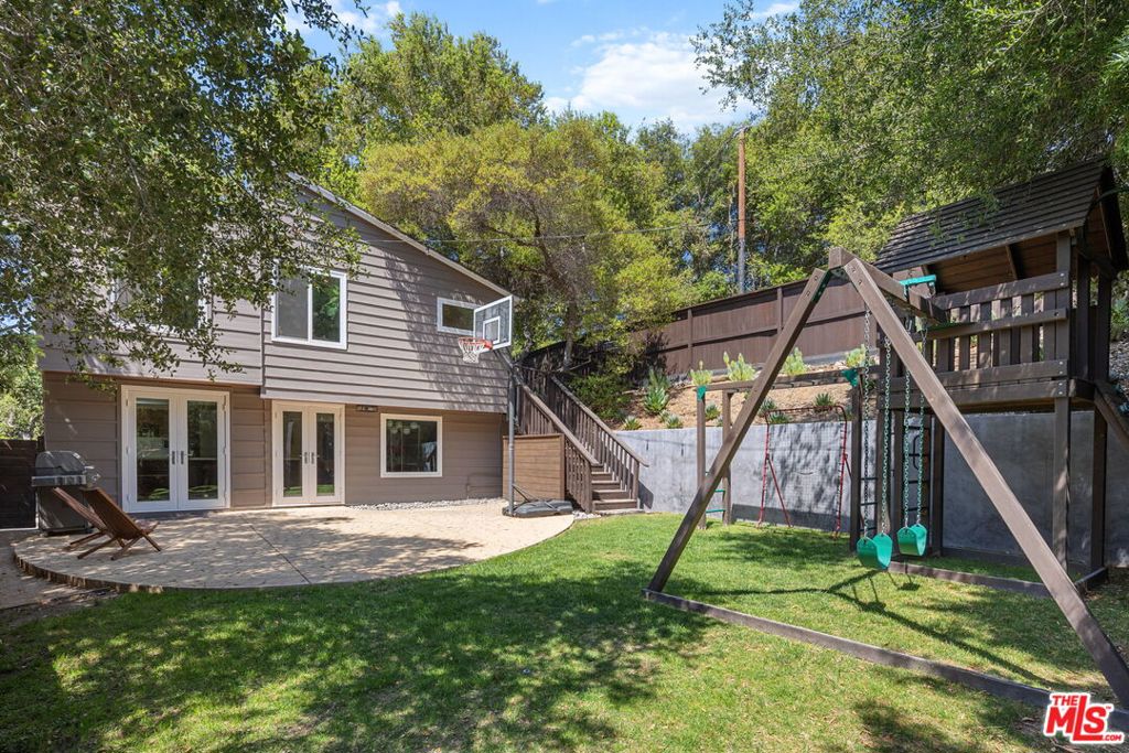 Seller Motivated - Move-in-Ready! Find serenity and comfort in this beautifully renovated, move-in-ready three-bedroom, two-bath Topanga home. Lovingly upgraded with a clean, modern aesthetic, this haven features wood accents throughout. The generous primary bedroom features warm wood floors and is large enough for a relaxing reading area or yoga space. French doors open to a spacious, wraparound deck. The second bedroom and vintage-inspired bathroom complete the upper floor. The upscale chef's kitchen features a welcoming breakfast bar and stainless steel Bosch appliances. Notice the care taken in creating the continuous grain walnut cabinetry. The clean lines of the smooth, white countertops complement the dark wood. French doors lead out to the restful patio and the fully fenced, grassy yard. The living room is the ideal spot for a game night or a movie night. A third bedroom suite with its own bathroom presents many options. A separate, one-room structure would make a perfect home office or art studio. A roomy storage shed and automatic-gated parking with an EV charger complete the scene. The extensive list of upgrades includes imported Italian wood flooring, Aquasana whole-house filtration, Milgard windows and doors, drought-tolerant landscaping with irrigation, and more. Minutes to the beach, local village shops, and neighborhood cafes. Nearby, the Topanga Community Center offers a weekly farmers' market, a scenic playground, a large ballfield, and fun events like Food Truck Fridays. Centrally located, the home is a 20-minute scenic drive to Santa Monica or Malibu, and a 15-minute drive to The Commons at Calabasas. This is a true gem in a natural setting. Escape the daily stress and live in Topanga!