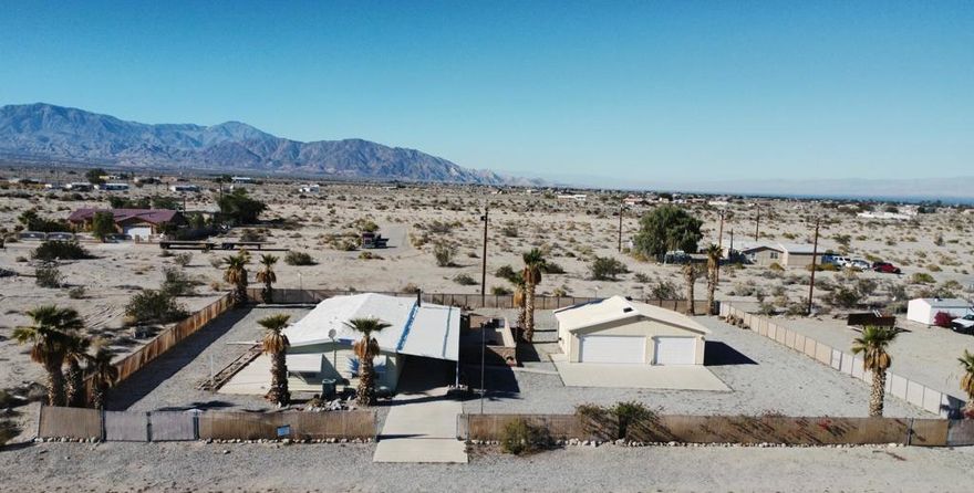 Spacious 2 bed, 2 bath manufactured home on nearly 1/2 acre. The property includes a large detached 3-car garage, plus extended covered parking ideal for vehicles, equipment, or off-road toys. Features an open layout with a generous living room, dining area, and functional kitchen. Fully fenced lot with plenty of space for storage and parking. Convenient access to Highway 86 and nearby amenities. Great opportunity for buyers looking for space and land.Amplia casa manufacturada de 2 recamaras y 2 banos en casi 1/2 acre. La propiedad incluye un gran garaje independiente para 3 autos, ademas de estacionamiento techado ideal para vehiculos, equipo o juguetes todoterreno. Cuenta con sala amplia, comedor y cocina funcional. Terreno completamente cercado con mucho espacio para almacenaje y estacionamiento. Ubicacion conveniente con acceso rapido a la Carretera 86 y servicios cercanos. Excelente oportunidad para quienes buscan espacio y terreno.