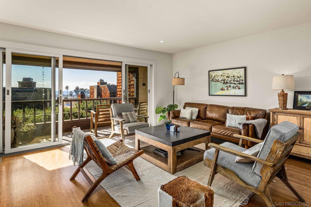 Enjoy ocean breezes and breathtaking water views from this exquisitely remodeled 3-bedroom, 2.5-bath townhome, nestled in the resort-style community of Sea Point. Thoughtfully designed, this home features luxurious upgrades, including bamboo hardwood floors, stainless steel appliances, gas fireplace, custom built-in closets in all bedrooms, and a fully finished garage. Skylights flood the space with natural light, enhancing its bright and airy feel. The unit features two patios and a balcony. The balcony offers a stunning vignette view of Torrey Pines beach. The home spans two levels, with stairs leading down to the bedrooms from the upper level where the garage is located. The decor strikes a perfect balance between earthy and cool ranch/beach vibes, giving the space a relaxed yet stylish feel. The primary bedroom features a king-size bed, the second bedroom includes a queen-size bed, and the den is equipped with a twin bed plus a twin size trundle bed. The community grounds are equally impressive, with towering, coniferous trees creating a gorgeous natural setting. Just steps from the pool, hot tub, a 4-acre park, tennis court, local dining, and a five minute walk to the beach, this home offers the ultimate coastal lifestyle in a serene natural setting. Additional highlights include air conditioning, beach paraphernalia, and a gas grill & walking distance to both the beach and the Torrey Pines hike, making this the perfect place to unwind and enjoy everything the area has to offer.