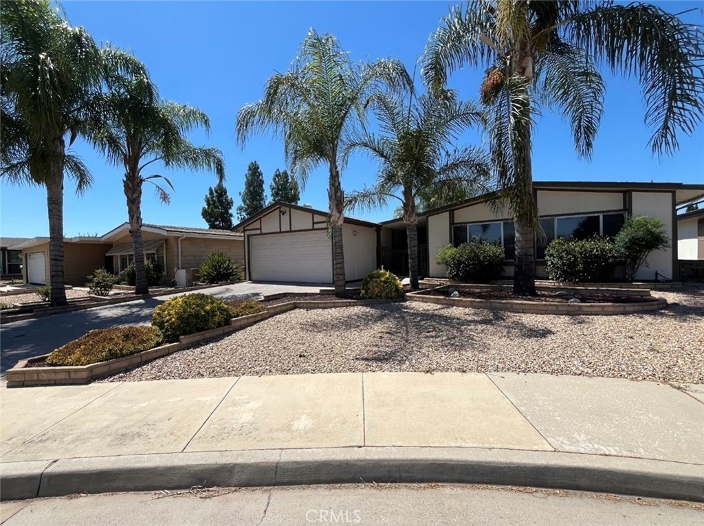 Seven Hills 55+ Community of Hemet, California. This 2040 sq ft residence offers two spacious bedrooms and two bathrooms, providing a comfortable and inviting living space. Seven Hills is a vibrant senior community centered around a public 18-hole golf course, offering residents a serene and active lifestyle. The community's tranquil environment and well-maintained surroundings make it a sought-after destination for those seeking both relaxation and recreation. The family room features built in bar area. The exterior offers desert landscaping for easy maintenance, a private backyard. A detached 2-car garage with an additional room/storage—perfect for a workshop or hobby space. RV parking area is conveniently located nearby.