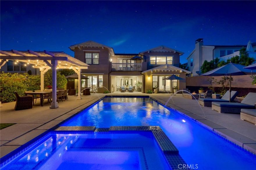 This is the one!  Adorned with sophisticated elegance this Residence 5 in Crystal Downs North in San Juan Capistrano on a gated cul-de-sac street has been fabulously upgraded and enhanced for relaxed living and entertaining in this absolutely perfect floor plan!  With 2 primary suites, one up and one down allows for flexible living lifestyles.  There are 5 beautifully appointed en-suite bedrooms as well as a main floor guest powder room.  You are greeted by dual porches, to take in the breezes and views.  Upon entry handsome wood flooring, custom wood shiplap walls, custom wood ceiling beams and custom built-in entertainment centers in both the upstairs and main floor family rooms! The primary suite with walk-in closet with custom built-ins, dual sinks, oversized shower and separate soaking tub awaits. The well appointed kitchen with an oversized island offers bar seating, Quartz countertops, double ovens, 6 burner range with griddle, butlers area, walk-in pantry and charming eating nook is a chef’s dream!  The folding glass door in the family room erases the line between indoor and outdoor living.  Enjoy the resort like backyard complete with private saltwater pool and spa with enormous baja shelf and jogging/swim lane.   The built in pergola provides an inviting space for outdoor dining and enjoy the bounty from your fruit trees and vegetable boxes!  Residents also have access to Club Pacifica, which offers a resort -style saltwater pool, spa, cabanas, fitness center, fireplace and barbeques.  Enjoy walks along the many trails and relax in Adirondack chairs strategically situated to take in the breathtaking views of the ocean and harbor!