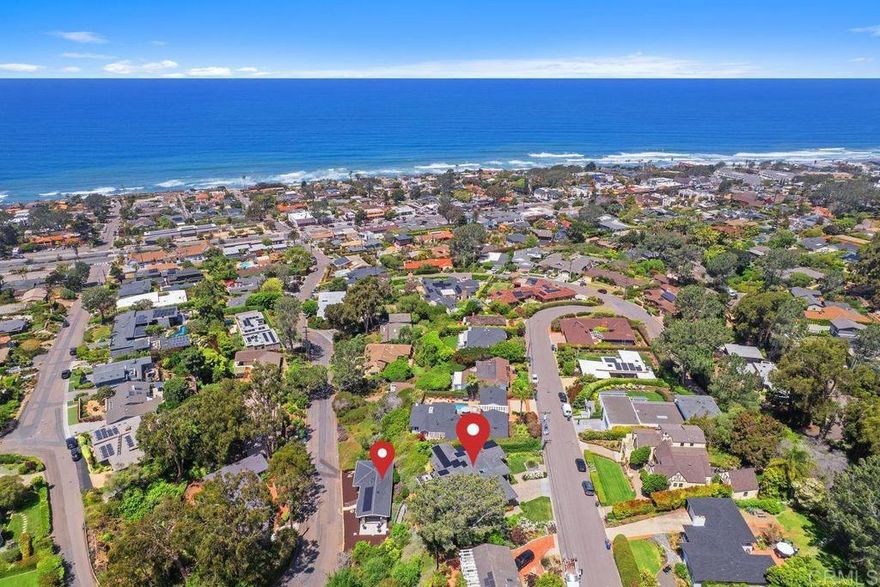TWICE as RARE and TWICE as remarkable. NEXT LEVEL VIEWS from the Main Residence and Guest House! Commanding more than 180-degree ocean views from its 1/3 acre elevation, just above Del Mar Village, this timeless 4,177 sq ft coastal compound embodies refined seaside living. The main residence offers 4 bedrooms and 3.5 baths, thoughtfully designed to capture sweeping vistas from nearly every room—including the kitchen, living room, office, primary suite, and a secondary bedroom. Wrapped in classic shake siding, the exterior exudes understated charm, while the interior is a bright, sunlit haven of relaxed sophistication. Expansive racking doors blur the lines between indoors and out, filling the open-plan living and dining areas with ocean breezes and golden-hour light. The spa-inspired primary suite is a true retreat, with stunning water views, private deck access, and a serene en suite bath. A standout feature of the property is the approx. 1,100 sq ft detached guest house, complete with 2 bedrooms, 2 baths, full kitchen, living area, and its own set of racking doors that open to a private patio—perfect for hosting guests, housing extended family, multi-generational living or producing income. Both the main home and guest house are equipped with solar, emphasizing sustainable luxury. The guest house can be accessed off 11th Street which offers ample parking or from a descending stairs from the main residence. Walking distance to the village of Del Mar  where charming shops, top-rated restaurants, iconic beaches and year-round fun await. Make breathtaking sunsets and coastal serenity part of your everyday life—this is Del Mar at its finest.