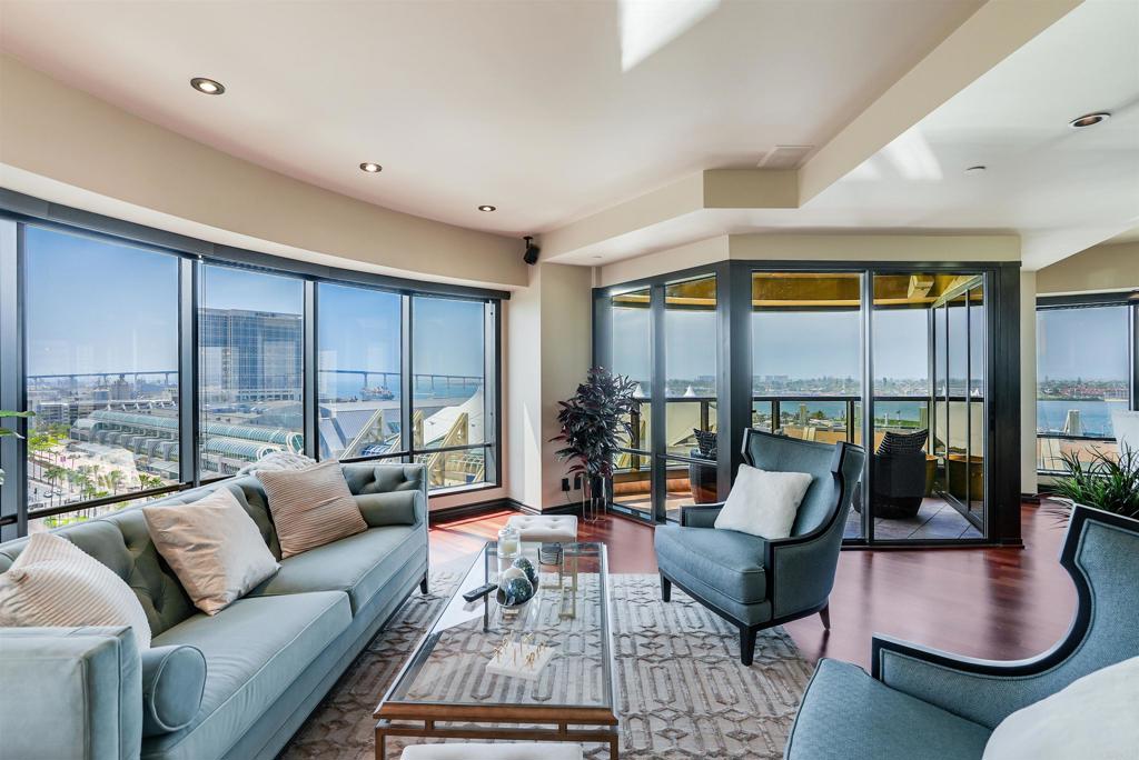This beautifully furnished 2,510 sq. ft. condo, known as The Bubble, offers an extraordinary living experience in one of San Diego's most iconic luxury buildings. The expansive floor plan includes two elegant living rooms, a bar, and abundant entertainment space, all framed by floor-to-ceiling windows that provide stunning 300-degree views of San Diego Bay, Coronado, Point Loma, and the Downtown skyline. The master suite is a true retreat, featuring maple Brazilian hardwood floors, etched glass French doors, marble countertops, and a steam shower. The suite is equipped with an integrated sound system, four televisions, and two AC units, ensuring ultimate comfort. Two spacious balconies provide breathtaking panoramic views of sunrises and sunsets, with exposures to the East, South, and West. Residents enjoy access to one of the finest community decks in San Diego, located on Level 6. This tropical oasis includes a 90-foot lap pool, jacuzzi, fire pits, BBQ areas, and a newly redecorated clubhouse/cabana. Additional amenities include a well-equipped fitness center and sauna. The unit also comes with two private parking spaces conveniently located on Level 4. Located in the highly sought-after Gaslamp Marina District, this property offers unparalleled convenience, with easy access to Seaport Village, the Midway, Embarcadero, Petco Park, and Little Italy. The building features a recently remodeled lobby with elegant marble and wood finishes, along with 24-hour concierge and security services, embodying the epitome of luxury living in San Diego.