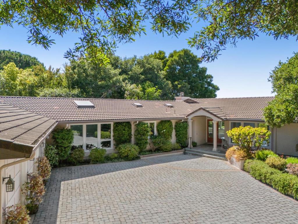 Experience the ultimate in California living with this spectacular one-level gated estate, offering breathtaking panoramic bay views and luxurious indoor-outdoor living. Thoughtfully designed by architect Ron Shimamoto for comfort, style, and privacy, this bright and spacious 4 Bedroom, 3 ½ Bath home features both formal and casual living spaces, including a detached home office. Soaring ceilings, gleaming hardwoods and a wraparound entertainment deck complete with a hot tub. Formal living & dining rooms and kitchen/family-room all with bay views flowing to the outdoor deck. The primary suite is a true sanctuary with serene garden views, a cedar-lined walk-in closet and a spa-inspired bath with dual vanities and soaking tub. The homes tranquil ambiance continues in the beautifully landscaped Zen garden, where pathways meander beneath a canopy of mature trees. Immaculate 3-car garage with storage and minutes away from Hillsborough's award-winning Crocker Middle School and West Elementary, with convenient access to I-280 for an easy commute. Welcome Home!