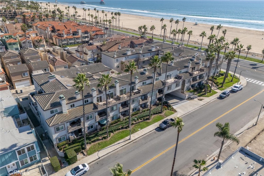 Live the California dream with sand, surf, and sunsets just steps from your door. Perfectly positioned along Pacific Coast Highway, this ground-level Huntington Beach condo captures the laid-back coastal lifestyle with a modern, upgraded twist. Step inside and you’ll instantly feel at home in the open floor plan, highlighted by newer luxury vinyl plank flooring, a newly renovated gas fireplace, and natural light pouring in through brand-new windows with custom treatments.
The kitchen is a total standout — thoughtfully redesigned with pull-out shelving, under-cabinet lighting, a gas stove with a custom vent hood, sleek countertops, and bar seating that flows effortlessly for entertaining. There’s even a wine fridge for those impromptu happy hours after a day at the beach. Through the new sliding glass doors, your private patio becomes an easy extension of the living space — perfect for morning coffee or watching the colors of the evening sky.
Both bedrooms offer ensuite bathrooms for comfort and privacy, while the spacious primary retreat features a deep walk-in closet and serene ambiance you’ll love coming home to. With a brand-new HVAC system, every detail has been considered for effortless year-round living. Simply walk across PCH to the sand or the walking and biking trails. Head to Main Street, Huntington Beach Pier or the popular 2nd & PCH Shopping plaza all just minutes away!
Whether you’re searching for your full-time beach home or a coastal weekend escape, this turn-key condo delivers the best of Huntington Beach — ocean air, walkable access, and a lifestyle that feels like vacation every day.