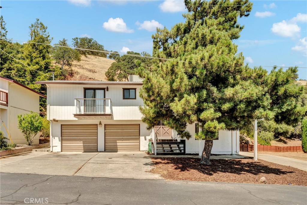 This beautifully updated 3-bedroom, 2-bath home offers modern comfort and exceptional versatility. Inside, you'll find brand-new appliances, plush carpeting, and stylish vinyl plank flooring that create a warm and sophisticated atmosphere. The balcony showcases breathtaking lake views, adding a serene touch to everyday living. Downstairs, a fully permitted BONUS STUDIO with a full bathroom and separate laundry hookups that provides an ideal space for rental income, guests, or a private home office. Central HVAC ensures year-round climate control, and the upgraded electrical system is ready for a separate meter, offering added flexibility. Located in a desirable lakefront community, residents enjoy access to a private beach, dock, pier, and boat launch—making this property a perfect retreat for multi-generational living or a smart investment opportunity.