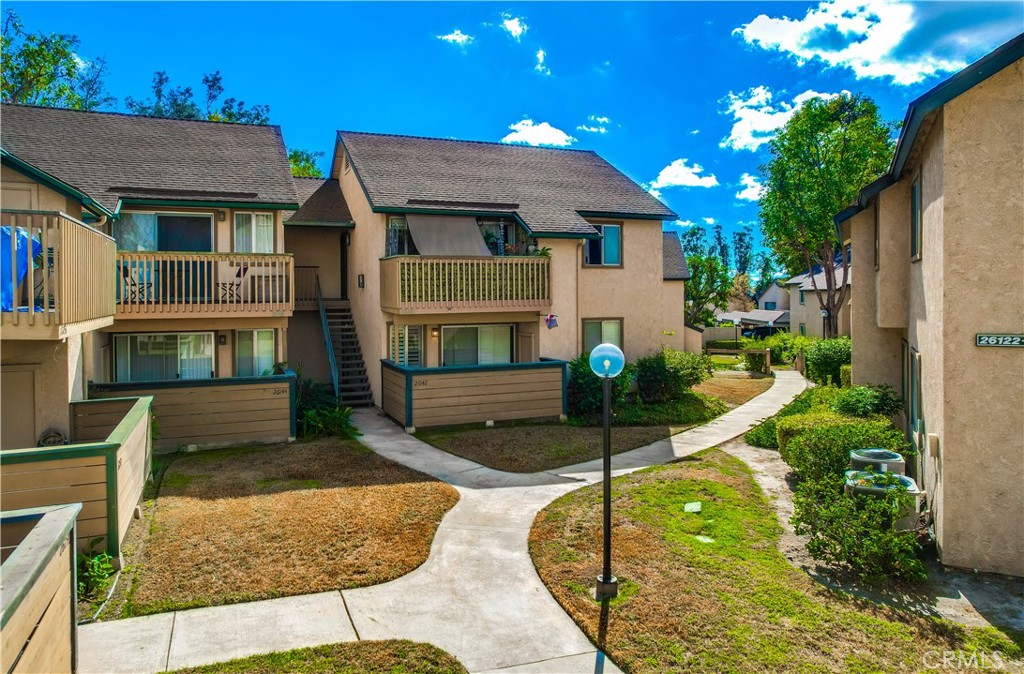 Beautifully updated and improved lower-level end unit in the desirable Serrano Creek Villas community, blessed with a peaceful and private location tucked back in the community surrounded by green spaces providing a peaceful living environment. Step inside and soak in the light and bright, freshly painted interior with new commercial grade scratch resistant Trail Oak Luxury Vinyl Wide Plank flooring throughout, crown molding, and plantation shutters setting the stage for an ideal living space. The spacious living room has direct access through sliders to the covered patio providing an ideal indoor-outdoor living space. The sparkling kitchen has updated soft close cabinetry, Quartz countertops, new hardware and pulls, undermount sink, subway tile full backsplash, stainless-steel appliances, a large walk-in pantry with plenty of storage, a laundry closet with full size washer and dryer, and a sunny dining area open to the living room, perfect for entertaining friends and family. Two spacious bedrooms with closet organizers, crown molding, plantation shutters, and a handsome upgraded bathroom with granite topped vanity, framed vanity mirror, updated lighting, and tiled shower surround with glass tile details. The covered, enclosed, private patio is a welcoming space for enjoying a morning cup of coffee with a loved one, al fresco dining, or relaxing and gatherings. Additional improvements include a New AC unit installed in 2023. Just a short stroll to the community clubhouse, pool, and spa. 1 covered carport space #253 included. Serrano Creek Villas is a quiet and friendly community with serene walking paths, an abundance of parking, surrounded by lush mature landscapes. HOA covers Water & Trash. Ideally located within walking distance of hiking, biking, and running trails, close to dining and shopping, easy Toll Road and 5 Freeway access, and just minutes from local beaches.