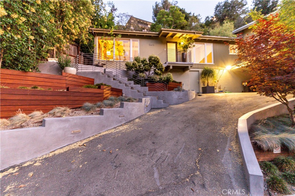 Nestled in the highly sought-after Los Feliz Oaks, this beautifully updated contemporary/mid-century modern residence offers privacy, luxury, and stunning canyon views on an expansive 21,038 square foot lot (0.483 acres). The home boasts incredible curb appeal, enhanced by Japanese Ipe wood planters that frame the front of the house with modern elegance. Surrounding the property is a curated collection of succulent plants—a personal passion of the owner—that brings life and texture to the landscape. This post and beam construction home has been recently remodeled with exceptional attention to detail. Recent upgrades include a redone roof, fresh interior and exterior paint, and thoughtful enhancements throughout. The sophisticated interior features expensive wall sconces that provide ambient lighting, while all bedrooms showcase new wool mix carpet for comfort and luxury underfoot. Inside, the chef's kitchen features exquisite original St. Charles custom cabinetry and a brand-new suite of appliances: dishwasher, refrigerator, washer/dryer, microwave, and oven. The living areas are equipped with an ACS alarm system, Ring doorbell, and mounted TV. Throughout the home, brand new Shade Store shades have been installed, while organized closet systems by Elfa maximize storage efficiency. The bathrooms have been meticulously updated with premium finishes. One bathroom features elegant marble floors, while the en-suite bathroom is fully remodeled with contemporary concrete floors and countertop. Both bathrooms are appointed with Waterworks faucets and showers, representing the finest in luxury fixtures. Step outside to your private pool retreat and newly redone deck—complete with all Modernica outdoor furniture included—perfect for entertaining or relaxing in style on the generous grounds. The location offers incredible access to hiking trails, including routes to the iconic Griffith Park Observatory and the renowned Greek Theatre, making this an ideal retreat for nature enthusiasts and culture lovers alike. This turnkey gem blends sophistication, comfort, and security in one of LA's most iconic neighborhoods, offering a perfect combination of contemporary luxury and California indoor-outdoor living on a rare, substantial lot.