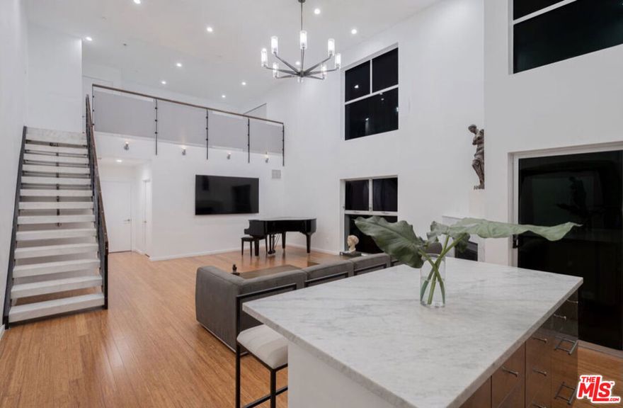 Stunning designer-furnished residence in the exclusive Hawthorn Lofts in the heart of Hollywood. This beautiful two-bedroom, two-bath loft features soaring 18-foot ceilings, marble floors, and elegant Restoration Hardware furnishings throughout. The spacious open layout offers a seamless blend of luxury and comfort, highlighted by a striking living area with a gas fireplace and floor-to-ceiling windows that fill the home with natural light. Enjoy a chef's kitchen with premium finishes, central air and heat, and two king bedrooms with beautifully appointed marble bathrooms. The home also includes in-unit laundry, two parking spaces, and access to the building's controlled entry and rooftop deck. Perfectly situated near dining, shopping, and entertainment, this sophisticated home delivers modern city living at its finest.
