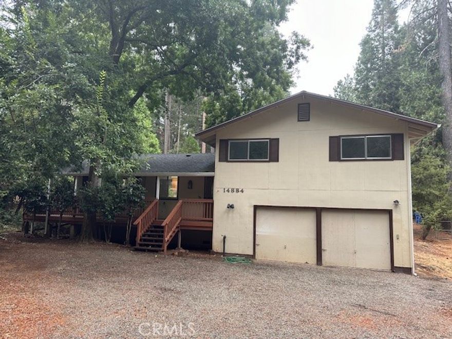 This home is surrounded by trees providing a secluded setting on .48 of an acre. The interior of the home has 3 levels; the main floor includes the kitchen, living room/dining room combo, half bath, and laundry room. Kitchen has tiled counters with eating bar. Spacious living room has wood stove and sliding patio door that leads to back deck overlooking the back yard. New laminate flooring/carpet in living room, kitchen, and laundry room. Upstairs is both bedrooms with the master and hall bathrooms. The master suite includes a double closet, walk in shower, and private deck. The textured 2 car garage on the ground floor is extra deep with walk in closet, shop area, and a bonus room on the backside of garage. This property also features a wrap around front porch, newer central heat and air unit, newer roof, and freshly painted interior.