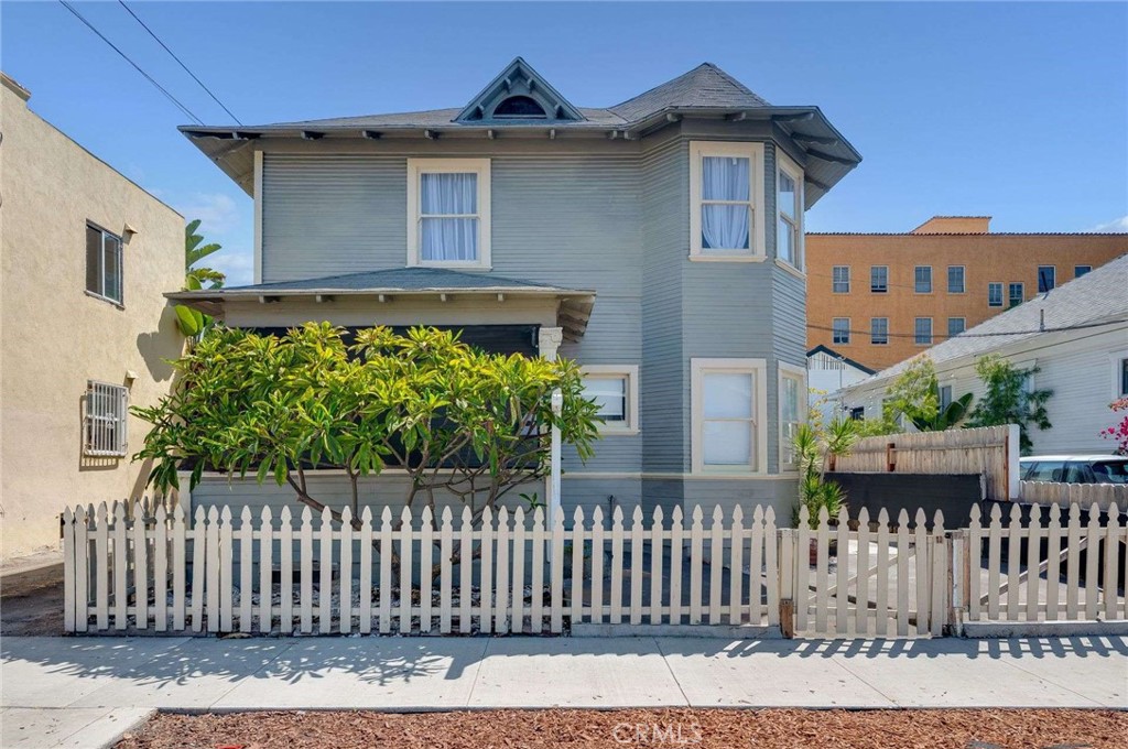 This late Victorian in the Wilmore Historic District is lovingly waiting for new owners. Sitting on a street that traces Long Beach’s origin story—steps from where civic life began (Cerritos Hall/First Church), near a 1920s high-rise showpiece (the Willmore), and within the broader Willmore City historic landscape. Updated to meet today's modern life, the home has an open and airy kitchen with white cabinets, quartz countertops, and stainless steel appliances. Large living room with an electric fireplace, a circular bay window, and a half bath for guests. In the back area is a primary bedroom with a bathroom. Upstairs are three large bedrooms, each with a private sitting area, laundry room, and a full bathroom with a clawfoot tub and shower. Other amenities include a tankless water heater, a mini split AC system, a water softener, and updated electrical. Close to the beach, the convention center, the Blue Line, bike paths, and the freeway.