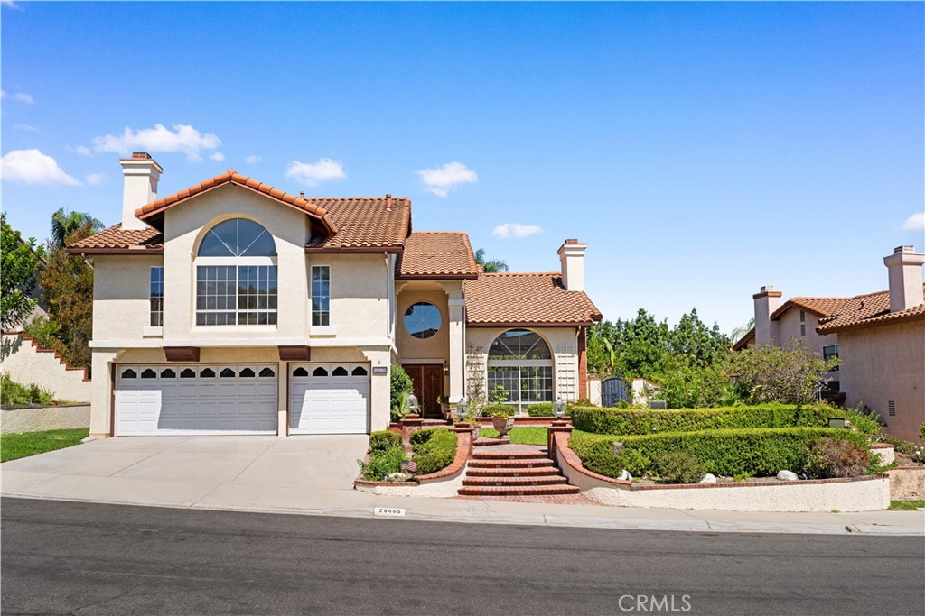 Immerse yourself in an elegant yet welcoming Newly Remodeled South Facing two-story home located in the desirable East Lake Village, offering just under 3,400 square feet of versatile space ideal for both family life and entertaining; as you step inside, a dramatic entrance unfolds into a generously designed living area illuminated by abundant natural light and anchored by a stone-feature fireplace, while an adjacent formal dining space with a reflective ceiling detail invites memorable shared meals and transitions smoothly into a modern kitchen equipped with high-quality stainless steel appliances, quartz counters, stylish tile work, and updated lighting—perfect for the inspired home cook; the open family room, complete with its own fireplace, feels warm and inviting and is complemented by a private ground-floor guest suite with its own bath that provides a comfortable retreat for visitors or multigenerational living; upstairs, a spacious bonus room with built-in shelving and a cozy fireplace offers flexible space for a media lounge, home office, or casual hangout, and the main bedroom serves as a peaceful sanctuary with balcony access, a refreshed spa-like bath, and generous proportions, accompanied by two additional well-sized bedrooms and baths; outdoors, discover a beautifully landscaped yard designed for year-round enjoyment, featuring a relaxing spa and multiple seating zones that make al-fresco gatherings effortless; practical amenities such as a three-car garage, convenient laundry room, and access to East Lake Village’s premium community offerings—including a private lake, clubhouse, pools, fitness center, and scenic walking paths—complete the picture, making this home not only an attractive residence but also a lifestyle destination where comfort, modern updates, and community pleasures come together in perfect harmony.