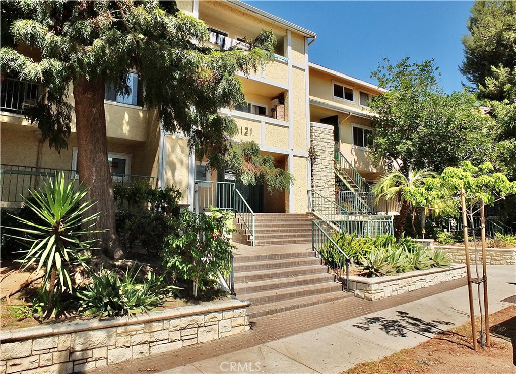 Welcome to Sinclair Gardens, where comfort meets convenience in this stylish two-story end-unit condo! Located upstairs, this 2-bedroom, 2-bath home offers a fresh, youthful vibe and an open layout designed for modern living. Enjoy beautiful wood floors, newer appliances, and the convenience of in-unit laundry tucked neatly into a dedicated closet. The kitchen flows effortlessly into the living area, creating the perfect space for relaxing or entertaining. Both bedrooms are generously sized with great natural light, and the two full bathrooms add to the comfort and functionality of this well-designed home. Two assigned parking spots are included for your convenience. Community amenities include a sparkling pool, fitness room, and a friendly, well-kept complex. The HOA covers most utilities—water, gas, and trash—leaving you responsible only for internet and electric. All of this is located just minutes from major studios, with easy freeway access, and close to shopping, dining, and everything that makes Glendale so desirable. Come see why Sinclair Gardens is the perfect place to call home!