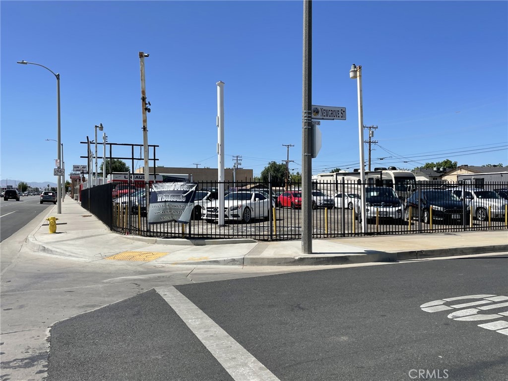 This property is located on the corner of Sierra Highway and Newgrove Street. The lot is fenced and secured with gated access from Newgrove Street plus rear alley access. Currently a used car sales lot, the property has electric, water and sewer. There is also an approximately 800 square foot trailer with offices and a restroom.