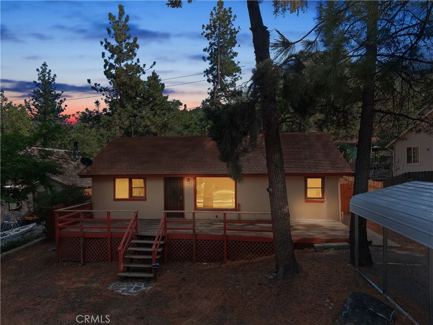 BACK ON THE MARKET!

Discover your perfect mountain retreat in the charming, tree-lined community of Wrightwood. This cozy cabin offers a versatile opportunity for vacation home seekers, investors looking for a rental property, or first-time buyers eager to embrace mountain living.

Nestled on a nearly flat, fully fenced lot, this quaint home boasts a practical 3-bedroom, 2-bath layout with a welcoming living room and functional kitchen. The property's secure perimeter ensures peace of mind for pet owners, while the tree-lined yard provides a picturesque setting and potential for future landscaping projects.

As you approach, a spacious front deck spanning the width of the home invites you to relax and soak in the mountain air. Step inside through the charming cabin-themed stained glass entryway into a cozy living room, where a large window frames breathtaking mountain views.

The primary bedroom offers privacy with its ensuite full bathroom, while two additional rooms on the opposite wing share an adjoining door, perfect for creating a home office or den if desired. The updated kitchen features new laminate countertops and a dining area, ideal for family meals or entertaining guests.

Maximizing living space, the laundry area is cleverly housed in an exterior built space. The backyard boasts a dual-door storage shed, providing ample storage for all your outdoor gear and equipment.

Whether you're seeking a weekend getaway, a lucrative rental investment, or your first home in the mountains, this property offers endless possibilities. With its prime location, thoughtful layout, and potential for personalization, this Wrightwood gem won't last long on the market. Schedule your viewing today and make this mountain home your own!