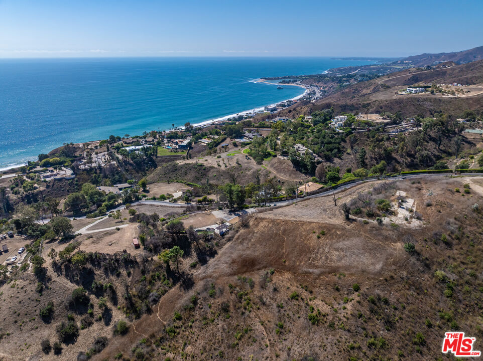 Seize a rare opportunity to acquire a 12+ acre assemblage featuring four buildable lots in the prestigious Carbon Mesa enclave of central Malibu, just moments from the vibrant dining and social scenes of Nobu, Little Beach House, and Country Mart, where the former home at 22105 Carbon Mesa Road was tragically lost in the Palisades Fire, leaving a flat 0.71-acre lot with intact pool and pavilion, boasting 360-degree ocean and canyon views with stunning sunrises and sunsets, plus coveted membership to La Costa Beach and Tennis Club; the sale also includes five additional parcels 22107 Carbon Mesa Road (APN 4451-012-027 approximately 0.75 acres) and four contiguous lots (APNs 4451-012-015, 4451-012-016, 4451-012-017, 4451-012-018) stretching behind the home site, over the ridge to Carbon Canyon Road, offering a unique chance to create a bespoke coastal estate in one of Malibu's most sought-after locations.