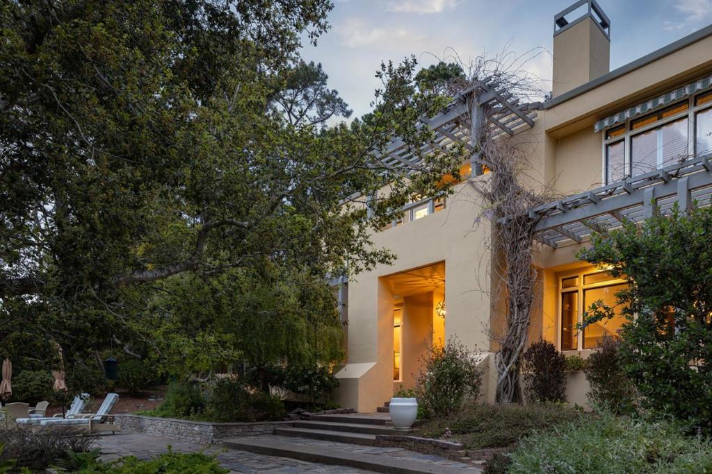 Nestled in the heart of Pebble Beach, 1579 Griffin Road is a spacious retreat spanning 5,503 SqFt, with 6 bedrooms and 4.5 elegantly appointed bathrooms. Set on a gated 1.13 acre lot, surrounded by the serene Del Monte Forest. It's the things you can't change about this property that make it special. Nestled next to open space at the end of a cul-de-sac, it offers easy access to hiking and outdoor adventures. Its west-facing orientation fills the home with natural light throughout the day. The property is serene, with a thoughtfully designed floor plan ensures seamless inside-out living, creating a rare and special place to call home. The chef's kitchen is a culinary dream with top-tier appliances, custom cabinetry, a French pizza oven, and a generous island and breakfast bar for entertaining. The kitchen flows effortlessly through French doors to the patio with a gorgeous outdoor fireplace. Other highlights include a lavish primary suite with a spa-inspired bath, dual vanities, and a walk-in closet, a 3-car garage, and lush gardens with fruit trees and meandering pathways. Just moments from iconic golf courses, world-class dining, and breathtaking ocean vistas, this Pebble Beach gem is an incredible opportunity to experience California's coastal elegance at its finest.