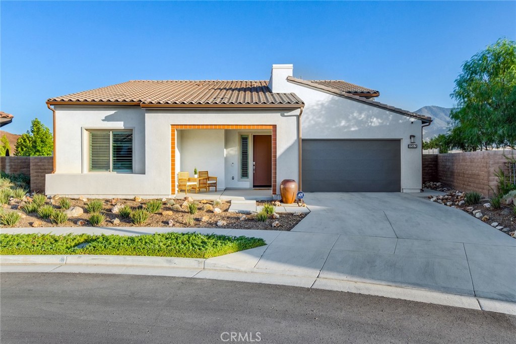 Welcome to 11565 Dovecoat Way – A Stunning Retreat with Breathtaking Mountain Views! Experience the ultimate in outdoor living at this exceptional single-story home, built in 2021, located in the vibrant 55+ community of Altis in Terramor. The expansive backyard is a true haven, offering serene mountain views that create a peaceful backdrop for relaxation and enjoyment. Whether you're soaking in the built-in spa or hosting friends in the beautifully landscaped yard, you'll appreciate the perfect blend of natural beauty and comfort. Step inside to discover the heart of this home: a magnificent great room that seamlessly combines the kitchen, living room, and dining area into one expansive, open space. The kitchen is a chef’s dream, featuring stainless steel appliances, a huge island that serves as both a buffet line and breakfast bar, and a walk-in pantry conveniently located across from the indoor laundry room. Large stacking sliding doors open up to the outdoor "California" room, enhancing your indoor-outdoor living experience. This space can be shielded from the sun with two retractable motorized screens, providing both comfort and flexibility for year-round enjoyment. The master retreat, situated in the back right corner of the home, is a spacious sanctuary featuring a large en suite bath with a roomy shower and double vanity with quartz countertops. The generously sized walk-in closet completes this luxurious space. Additional features include a powder room conveniently located off the hall near the den, and a full bathroom serving the two bedrooms at the front of the home. There is an additional den as well. This property sits on one of the larger lots, where thoughtful use of space includes a built-in six-person spa, concrete patio, and meticulous landscaping. The garage is equipped with a tankless water heater, water softener, and reverse osmosis system, alongside ample room for two cars and additional storage. As a resident of this active community, you'll enjoy a wealth of amenities such as community garden, pickle ball and tennis courts, bocce ball, indoor and outdoor pools, and a clubhouse featuring various spaces including a bar and meeting rooms. The clubhouse serves as the hub for community events, gatherings, and numerous clubs that offer opportunities to explore new interests and make new friends. Guard gated community for added security. Don’t miss the chance to make this extraordinary property your own. Your perfect home awaits!