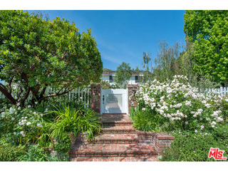 Gated Elegant East Coast Traditional located on the desirable WEST side of N. Oakhurst. This 4 BD/6 BA home is on a lrg private lot w/ mature gardens, pool/spa, gst hse & attached 2 car garage. Enter through a white picket fence & step into the entry w/ a lrg living rm w/ frplc & bay window to the left & formal dining rm w/ wainscoting & bay window to the right. The remodeled chef's kitchen adjoins a great rm w/ frplc & refrigerated wine rm. Light floods both the great rm & add'l sun rm which both have French drs to the bckyrd. A wood paneled office & add'l bed and ba complete the downstairs. A gracious spiral staircase leads upstairs to a master suite w/ a spectacular ba and walk-in closet, 2 bedrm suites & an add'l playrm /2nd office. The generous bckyrd includes a lrg grassy area, 2 brick patios for entertaining, romantic vine-laced loggias, mature trees, built in BBQ, pool/spa. The charming 1-bedrm Gst Hse has a ba, living area, kitchenette, add'l 1-car garage, storage rm & gym