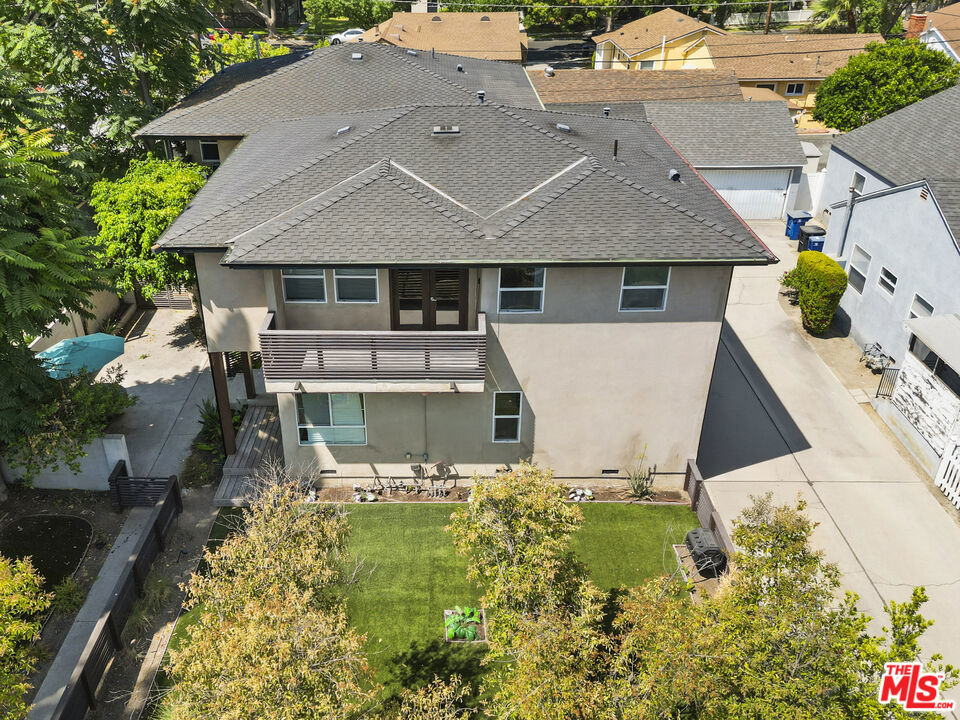 This contemporary townhouse-style duplex in Burbank offers a rare opportunity for both homeowners and investors in one of LA's most dynamic neighborhoods. Located just minutes from the major studios and the heart of the Burbank Media Center, the property is also close to movie theaters, top-rated restaurants, Griffith Park, and popular outdoor activities like hiking and horseback riding. With quick access to multiple freeways, commuting is easy Downtown LA is just 15 minutes away. Built in 2006, the duplex features two spacious units in a front-and-back layout, each 1,843 square feet with a desirable four-bedroom, three-bathroom configuration. Each unit includes two bedrooms on the main level and two upstairs, with generous living areas on both floors. The bright main living room flows directly into the kitchen, creating a layout perfect for entertaining. Kitchens are equipped with wood cabinetry, Miele stove tops, sleek black countertops, and ample storage, while wood flooring throughout adds warmth and continuity. Upstairs, each unit features a large family room that opens through double glass doors to a wide wraparound balcony. The primary upstairs bedroom opens directly onto the balcony, bringing in natural light and offering views of the surrounding neighborhood and treetops. The front unit has a generous courtyard and deck for additional outside enjoyment. The back unit also boasts a private backyard with mature shade trees and a patio perfect for entertaining or quiet relaxation. A two-car garage with a shared driveway is located at the rear of the property. One unit is currently rented for $5,220 per month, while the other unit is vacant and available for showings. PLEASE DO NOT DISTURB THE TENANTS! This is a fantastic investment opportunity with strong rental potential in a high-demand area.