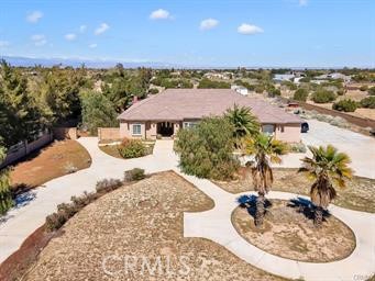 BEYOND ESTATES PRESENTS: SPRAWLING WEST PALMDALE ESTATE ON OVER 2.5 ACRES – PRICED TO SELL! Experience luxury and space in this stunning 4-bedroom, 4-bathroom single-story estate, perfectly situated on nearly 2.5 acres in the heart of West Palmdale. Just half a mile from the Antelope Valley Mall, this expansive home boasts 10-foot ceilings, an open-concept kitchen with rich wood cabinetry, granite countertops, and stainless steel appliances, plus both formal and family living rooms designed for comfort and entertaining. The grand master suite features two oversized closets and an upgraded spa-like bathroom, while a private guest bedroom with its own full bath offers extra convenience. Step outside to a massive backyard patio with a pergola, perfect for hosting gatherings or enjoying peaceful desert sunsets. A circular driveway and a spacious 3-car garage provide ample parking and storage. With over 3,200 square feet of living space, this home is an incredible opportunity—don't miss out!