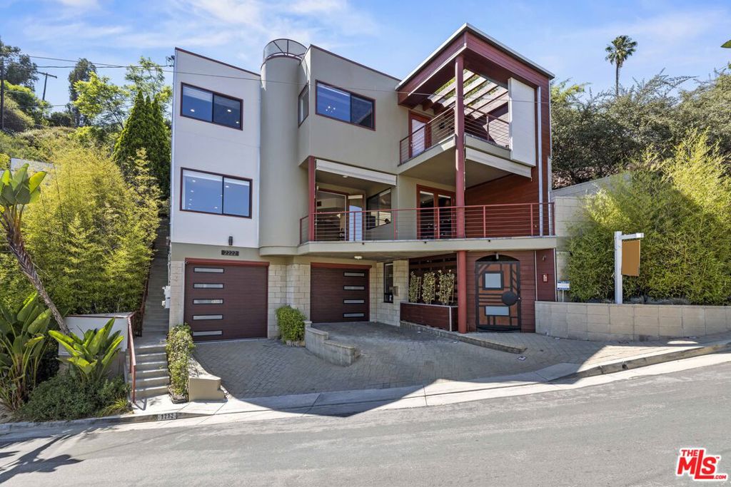 There are homes that are recognized and appreciated properly by very few. In a world overwhelmed by an avalanche of new construction focused on maximizing square footage and stacking ADUs, it's important to remember that the most meaningful things in life are not measurable by an appraiser's ruler. They are measured by energy, by presence, and by the ease with which life flows in a space. This home is a story of true love. A story of falling in love - with this home, and with each other - rooted in the understanding that details matter, and that craftsmanship does too. Because that is the only way to create something meaningful, something that endures through the decades. Welcome to Casa Alta - your serene perch above it all in the hills of Silver Lake Heights. A one-of-a-kind architectural compound where privacy, design, and inspiration meet not only for the moment - but for a lifetime. Per sempre, as some people with an intriguing accent might say. Your first introduction to this home begins with the garage - a thoughtfully executed two-car structure, with an additional two spots just outside in the driveway. The system behind the 30-panel solar array installed on the property could be found here too. From the first moment, your home greets you with natural materials - but it doesn't warm up to you right away. It says hello with cooler textures: concrete, metal, and stone. Think of this entry foyer as a secured portal that could easily transform into a lounge or bar area. As you enter the main level, you'll find the open floor plan that everyone desires. Not the kind of openness that feels like a warehouse or an echo chamber, but a deliberate, nuanced layout where the living room, kitchen, and dining areas coexist with balance and autonomy. The luxurious kitchen (top-of-the-line appliances from Fisher & Paykel, Bosch, custom cabinets, etc) steps aside gracefully, letting the view and the natural flow of the space take center stage. The home begins to soften here, with slate tiles placed where needed, and the warmth of Brazilian Tigerwood flooring grounding the entire level. A massive wraparound balcony floods the interiors with light, breeze, and life. One thoughtful feature is the outdoor staircase - perfect for entertaining - allowing guests to reach the backyard from the main level or even the street, without entering private spaces like the bedrooms. Because there are some corners meant to remain invitation only. The home's consistency and flow are unparalleled. And nowhere is that more evident than in the primary suite. Exposed beams in the bedroom carry on a visual dialogue with the Brazilian Tigerwood flooring, echoing the green hills of Silver Lake and Echo Park seen just outside your windows. A cedar-lined walk-in closet elevates the organic feel of the space, and of course - a private balcony. The bathroom is an experience unto itself, with a steam shower, hammered copper sinks, and an oversized iron soaking tub - a testament to craftsmanship and taste. Two additional bedrooms complete this floor - one of which has direct access to a perfectly manicured private backyard. But perhaps the most striking reveal is the detached studio - complete with its own secret garden. A jewel box perched atop the hill that will inspire even the most grounded and rational among us. This flexible space is ready to meet whatever purpose your imagination can dream up, including possible conversion to an ADU. Directly beside the house is a terraced lot - ripe for a vegetable garden, or even another home. The separate parcel, over 9,000 square feet in size, is optional for the buyer with vision of residing in a larger compound. Not all homes are created equal. Casa Alta is unique in countless ways - and now, we're in search of someone equally special. Someone who doesn't just understand this home, but feels it. Someone who can appreciate it for what it is, for what it could be, and for who they themselves could become while living here.