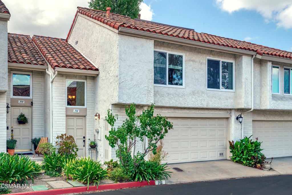 A rare offering in the sought-after Green Meadow Estates, this largest model features 1,550 sq ft with 3 bedrooms and 2.5 baths. The spacious backyard backs to lush, private grounds--an exclusive feature in this community. Step inside to a welcoming foyer with a powder room and access to the 2-car garage with laundry. A few steps up, the open living room boasts soaring cathedral ceilings, wood-like floors, a brick fireplace, and views of the garden patio. The adjacent dining area and bright kitchen feature updated cabinetry, pullout drawers, and built-in shelving. Upstairs, two bedrooms share a full bath, while the primary suite offers a remodeled bath with a walk-in shower and upgraded vanity. Additional highlights include dual-pane Milgard windows, recessed lighting, wood flooring, newer HVAC, and an alarm system. Enjoy sunsets in the serene backyard and community amenities including pool, spa, clubhouse, and guest parking. Don't miss this special home!