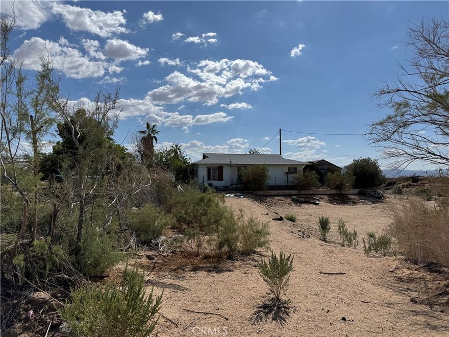 Great opportunity to own 5 acres of fully fenced land in Newberry Springs. The property includes a 3-bedroom, 1-bath, plus a private well and septic system already installed. There’s plenty of space to build, expand, or enjoy as a weekend desert getaway. Located on a quiet unpaved road, but still close to the freeway for easy access. Wide open views, peace and quiet, and tons of potential—come see what you can do with this property!