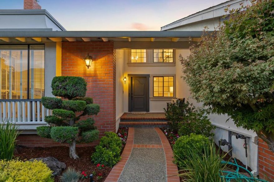 On a tranquil cul-de-sac near Laurelwood Park is a family-friendly home ready for the next generation. From the curb, the home is traditional in style with neatly manicured trees, shrubs and emerald lawn, and red brick detailing that carries to the façade and front porch. Inside, the drama begins.      The front door opens to a two-story foyer that astounds with sweeping hardwood floors, soaring vaulted ceilings, skylights and spacious rooms with generous windows, boasting 2,960+/- sf of interior living space. A greeting room with wet bar, grand living room with stately fireplace and elegant dining room set the stage for formal entertaining, while the great room is ideal for laid-back gatherings, with the family room, kitchen and breakfast area opening to the backyard patio for yet another entertaining venue.  For quiet retreat, three of four bedrooms are on the first floor, including Suite 2 with backyard access. Suite 1 occupies the entire upstairs. While both have walk-in closets and ensuite baths, Suite 1 has an office, a sitting room, fireplace, kitchenette, private study and terrace overlooking the flourishing backyard landscape with sculpted patio.