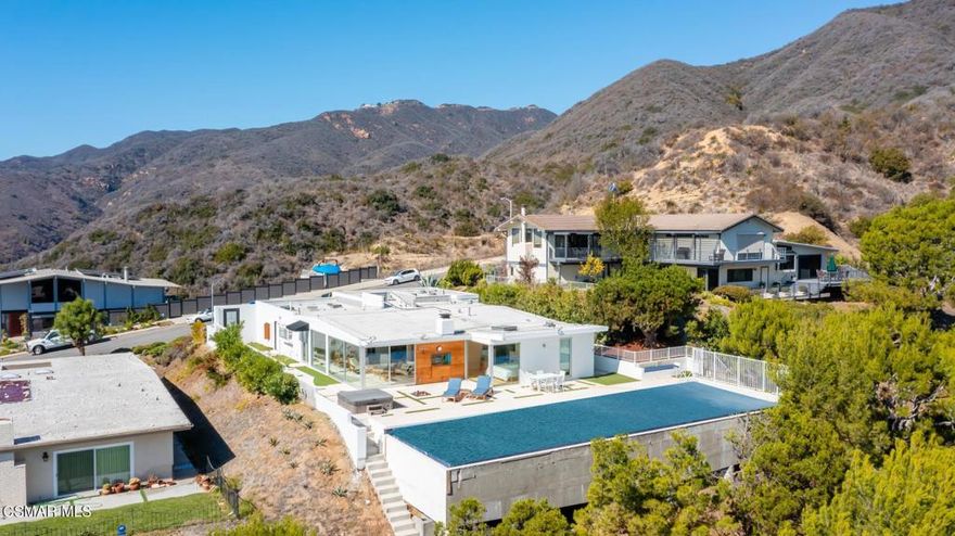 Located on the pinnacle of the desirable Sunset Mesa community, this striking contemporary beckons with panoramic ocean, coastline and mountain views throughout. The modern and updated kitchen boasts beautiful Lapis Lazuli stone and snow white marble, along with top of the line appliances. The welcoming floor plan offers high ceilings and a great room that opens to the custom outdoor entertainment area. Enjoy the amazing sunsets from various outdoor seating areas, including a fire pit. Other features include a freshwater indoor/outdoor aquarium wall, a putting green and an amazing 60 foot lap pool. An incredibly flexible floor plan offers the opportunity to lock off a separate 1 Bd + 1 Ba apartment with living area and full kitchen. This magnificent home offers a very quiet, private and serene setting while being conveniently situated minutes away from wonderful beaches, shopping and dining.