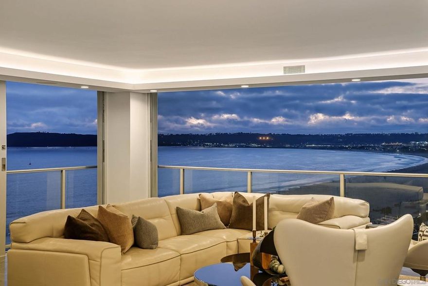 Rising high above the coastline on the 14th floor, this rare 3-bedroom, 3-bath Coronado Shores oceanfront residence embodies the pinnacle of sophisticated coastal living.  A custom large-format picture window serves as the home’s centerpiece, framing sweeping unobstructed views of the Pacific Ocean, Point Loma, and the iconic Hotel Del Coronado.  Inside the residence is a showcase of refined design, featuring dramatic Black Marquita marble tile floors, sleek Neolith porcelain countertops, and European laminate cabinetry with precision-engineered Legrabox drawers by Blum.  The chef’s kitchen is equipped with premium Miele appliances, while a custom integrated sound system provides the perfect backdrop for both elegant entertaining and serene daily living.    Beyond the residence, the Coronado Shores offers an exclusive lifestyle with oceanfront pools, tennis courts, pickleball courts, a private clubhouse, and 24-hour security, all just steps from Coronado’s world-renowned beaches, fine dining, boutique shopping, and legendary Hotel Del Coronado.    Blending timeless elegance, modern luxury, and a premier oceanfront address, this extraordinary property is designed for those seeking a one-of-a-kind coastal retreat.  Schedule your private viewing today and experience the height of ocean-front Coronado living.