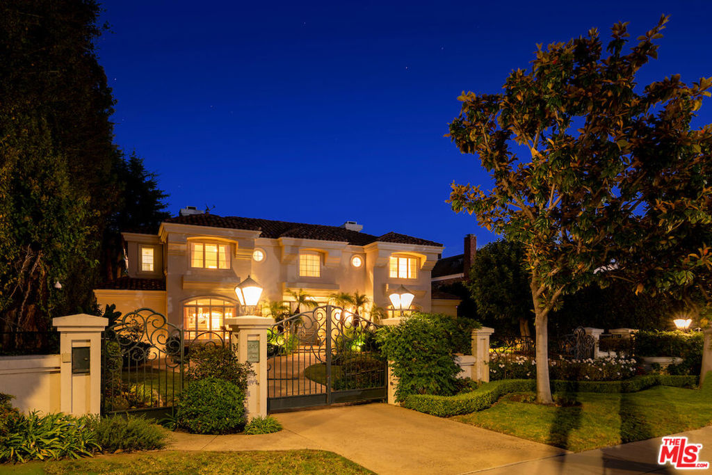 This spectacular Beverly Hills tennis court estate has been artfully designed by one of the top architects and builders on the Westside. The stunning estate includes an 8,800 +/- SF main house with 4 bedrooms and 6 bathrooms plus a 1,300 +/- SF guest house with two bedrooms and two baths spread across a 33,720 SF lot with an ideal floor plan. Just past wrought iron gates, lush landscaping, and a spacious motor court, the skylit double-height foyer leads to a generous entertaining area, adjacent to both the sunken formal living room and grand formal dining room, all outfitted with stone fireplaces. Additional plush first-floor living areas, den/office, classic custom kitchen and breakfast room provide functionality and ample space for all types of gatherings. A stately staircase or elevator to the upstairs leads to a truly grand primary suite, with custom walk-in closets and a spa-grade dual bathrooms, overlooking the secluded yard via private balcony. Accessed through French doors, the park-like property comes complete with a romantic terra cotta terrace, grassy play area, shimmering pool and spa, professional-grade tennis court, and the spacious two-story guest house. Generous hotel-like suites for all secondary bedrooms feature the same high-end attention to detail while being dispersed throughout the estate for the ideal balance of privacy and functionality, including one with a separate staircase and entry from the outside. This Beverly Park level build is apparent from the entry and its flawless execution of size and space. Perfectly situated midblock between the Beverly Hills, Peninsula and Waldorf hotels along with world class shopping and restaurants.
