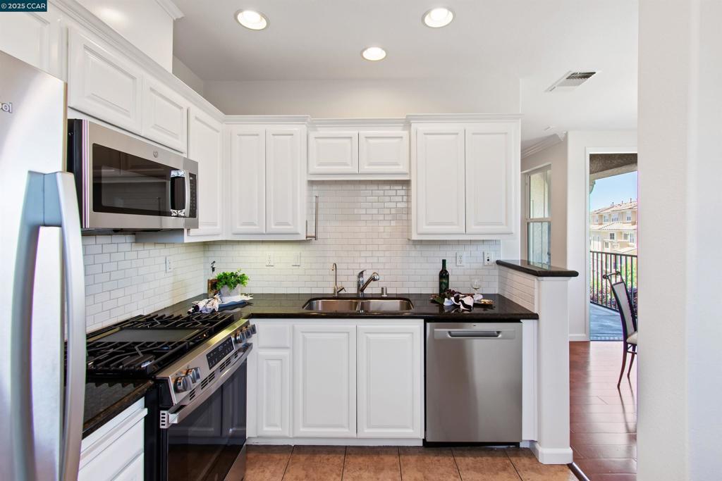 Charming living space with resort-style amenities in an ideal East Dublin location. Brand new paint, carpet, stainless gas range, microwave and dishwasher. Welcome to The Terraces of Dublin Ranch Villages, a luxurious four-story gated community with lush gardens, fountain courtyards, resort-style pool, patios, clubhouse, fitness center. Inside corridors, elevators, gated entry, 2 side-by-side parking spaces in a secured garage. Premium 3rd-floor end unit. 1124+/- light-filled SF. Hardwood floors, crown molding, recessed lighting. Living rm w/electric fireplace & carved mantel. French door to north-facing balcony, hillside views. Kitchen w/granite counters, subway tile backsplash, stainless sink. 2 bed / 2baths includes primary suite w/walk-in closet, and en suite w/dual-sink vanity. In-unit laundry nook. Full-size w/d. New water heater. Central AC. Adjacent to Bray Commons Park, five acres of parkland w/bbq grills, picnic areas, basketball & volleyball courts, playground, walking paths. Within a mile of Fallon Gateway shopping & restaurants. Near SF Premium Outlets, Fallon Sports Park, highly-acclaimed schools inclds the new Emerald High School within walking distance and Los Positas College, less than a 6-mile drive. Convenient access to freeways & BART stations.