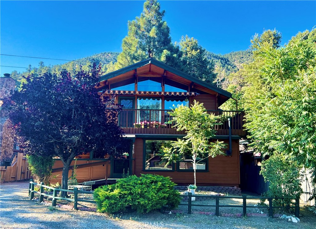 This beautiful Lindal Cedar Home has been well loved and maintained by the original homeowners who built it. Exterior is freshly painted with a new roof. You must see it to truly appreciate the incredible craftsmanship of woodwork, knotty pine ceilings, custom cabinetry, shelves, skylights and expansive windows! As you walk through the doorway into the lower floor you will find a sunlit entry room that would make a great art studio or office. Just inside is an open extra living space with a kitchenette and 3/4 bath. Step down into the sunroom with large windows and custom shelves for a great place to relax during the summer, and the gas fireplace will keep you warm and cozy in the winter. Through the door is a large pantry area that leads to the garage. As you walk up the stairway to the second floor you'll see a built-in book case. The spacious living room has a vaulted knotty pine ceiling, gorgeous windows and glass doors that open to the wraparound deck with retractable awning where you can sit and enjoy the panoramic mountain views and starry nights! The living room opens to the dining area with sliding glass cabinets, breakfast bar and kitchen with custom cabinets and skylight. Just up the hallway is a full bath with skylight, bedroom and primary bedroom with attached bathroom. Located just 40 minutes from Santa Clarita and Bakersfield, in a quaint mountain community with a slower paced lifestyle and 4 seasons of nature. This lovely and unique home in Lake of the Woods is a MUST SEE!!