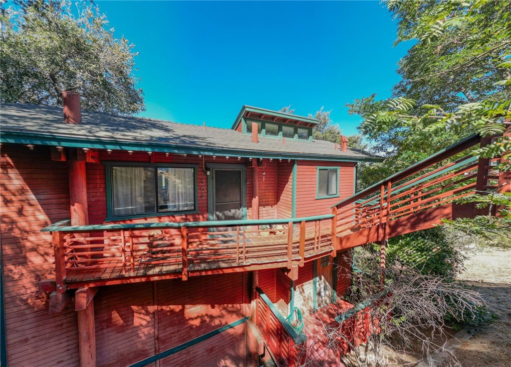 Stunning 2BR/1.5BA mid-century modern cabin on Lake Gregory's northeast shore with breathtaking panoramic lake and mountain views. This architecturally unique property blends classic cabin charm with sophisticated mid-century interior design, featuring dramatic exposed beam ceilings and walls of windows framing spectacular scenery.
The open-concept interior showcases a modern galley kitchen with stainless steel appliances flowing seamlessly into dining and living areas under soaring beam ceilings - perfect for entertaining while enjoying incredible lake vistas.
Two private patios offer ideal spaces for morning coffee or sunset cocktails overlooking the serene lake. Meticulously maintained over the years, the property includes above-grade parking for two vehicles plus additional street parking.
A rare opportunity to own Lake Gregory's northeast shoreline - the perfect retreat combining tranquil lakefront living with distinctive architectural character. Whether as a primary residence, vacation getaway, or investment property, this cabin offers an unmatched lifestyle in one of the area's most coveted locations.
Don't miss your chance to own lakefront paradise with views that never get old.