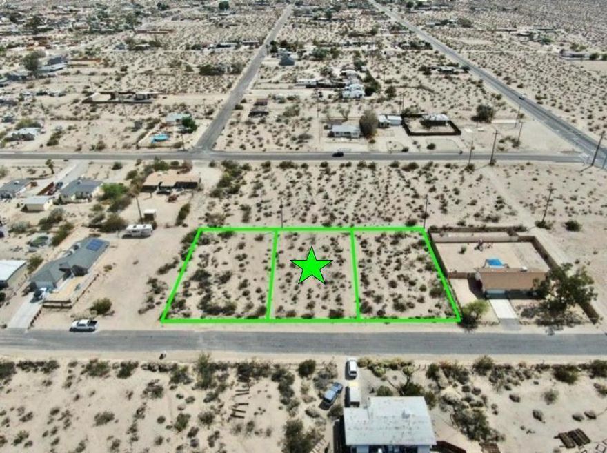Owner may carry! Turn Key lot with utilities and paved road. 11,100 square foot (quarter acre) lot the trendy Hanson Area neighborhood in 29 Palms! Ideal for a developer or long term investor. The Hanson Area is known for its views. Set on a gentle incline offering northern vistas of the Bullion Mtns. To the west are the boulder studded Little San Bernardino Mtns with Joshua Peak. To the east are the Twentynine Palms Mtns. Quiet neighborhood. Close to the 29 Palms Restaurant and Inn, Theatre 29, and the Tortoise Rock Casino. Just down the road is the 29 Palms gate to the Joshua Tree National Monument. About  3 million tourists visit the park annually. Great vacation area. A few miles to the north is downtown 29 Palms with the new Freedom Mall and all amenities. Celebrities, artists and musicians are now calling 29 Palms home more than ever before. Would be great for a designer modern home or go with a prefab manufactured. Buyer must contact the city for all questions on building and usage. Buyers must contact the utilities agencies for all questions on utilities. APN: 0624-012-18-0000 Address is not a real address and for marketing purposes only. GPS: 34.122244, -116.035248 Don't Wait! Call Now! Additional parcels also for sale APNs: 0624-012-19-0000 & 0624-012-17-0000