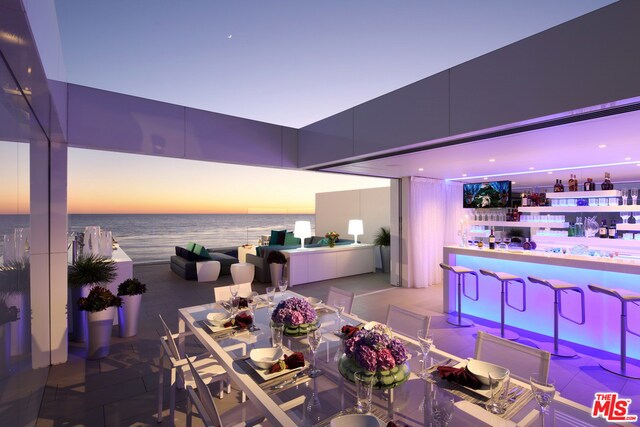 Modern design and architectural features unite in this newly remodeled three-story contemporary beachfront home by world-renowned architect Richard Landry. Pure white Nano Glass slabs & plaster wall finish were used to create crisp lines and precise detailing, giving this open floor plan home a light, airy feeling & providing a clean backdrop for special mood/ambience lighting features. Steps to the beach, the first floor includes an ocean front living room with fireplace, dining area & gourmet island kitchen with outdoor entertaining deck. The second floor owner's suite with fireplace, private deck & spa-like bath has a second glass wall that floods the floor with natural light, but can be closed with automated shades/draperies for privacy. The ultimate indoor/outdoor recreation space is created with pocket doors that completely open between the media room, custom bar & roof terrace with fire pit and built-in BBQ. Located behind the gates of a private subdivision off Broad Beach Road.