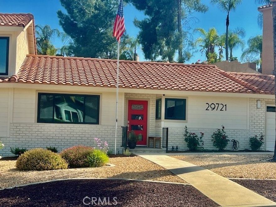 Very large 3 bedroom/2 bath home with open concept living and all the bells and whistles! New windows throughout, new laminate wood flooring, whole house fan, new quartz countertops in kitchen and bathrooms, updated stone showers, upstairs laundry...all the things people have on their "must have" lists including new kitchen stainless steel appliances and walk-in closets in each bedroom. Owner is an interior designer and has turned this ordinary house in to a modern model home! As you enter the home, the dining room is on the left and is well equipped to host your next formal dinner party. Your company will flow right into the living room complete with stacked stone fireplace to cozy up to. If you like reading spaces, the very large living room invites you to sit and enjoy the natural light from the slider which leads to the backyard and nature. Family game night can be had in the dining area which also has beautiful tall windows and is right off the kitchen. The kitchen has new appliances and a breakfast bar with a lower wine rack area to make both spaces multi-functional. There are two big bedrooms off the living room and both have mirrored walk-in closets. You'll the private primary suite upstairs which has its own balcony, dual sinks, stackable washer and dryer, and huge walk-in closet. BONUS!!!  Bring the inlaws or guests because this home also boasts a new area which has an office/bedroom/hobby room with its own bathroom and a utility room that can have another stacked laundry area and a mini-kitchenette. Outside is a covered patio lanai complete with big screen tv for those who like outdoor dining and entertaining. The backyard is also mulit-level with two areas for entertaining, dining, and for the kids to build their out door forts and tents. This is a rare find so put this on your MUST SEE list!