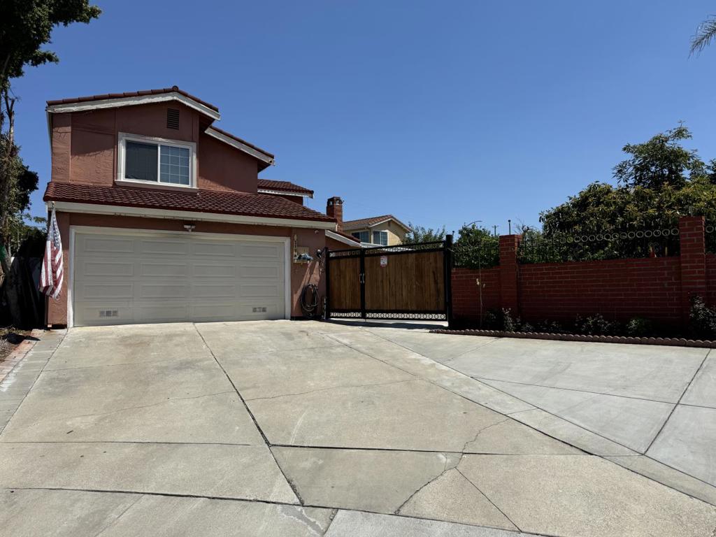 Welcome to this beautiful 4-bedroom, 3-bathroom home tucked away in a quiet, family-friendly court perfect for anyone looking for space, comfort, and flexibility. Set on a large lot filled with mature fruit trees, lush grass, and tons of outdoor space, it's ideal for entertaining, gardening, or simply enjoying the fresh air. The long driveway fits up to 5 cars, with additional parking space in the backyard. The home also offers a 2-car garage with plenty of storage for tools, gear, or seasonal items. The garage features generous built-in cabinetry, and with a few simple upgrades, it has the potential to be converted into a fully functional second kitchen! You'll love the hardwood floors, beautiful kitchen, cozy guest room, and two family rooms, including a custom-designed space that's perfect for movie nights or just relaxing with friends and family. There's room to build a spacious ADU, whether you're thinking about extra income, a private guest house, or multigenerational living. Located in a safe, quiet neighborhood on a court where kids can safely play outside, and just minutes from parks, top-rated schools, and shopping centers, this home truly has it all. Come take a look and imagine the lifestyle waiting for you here!